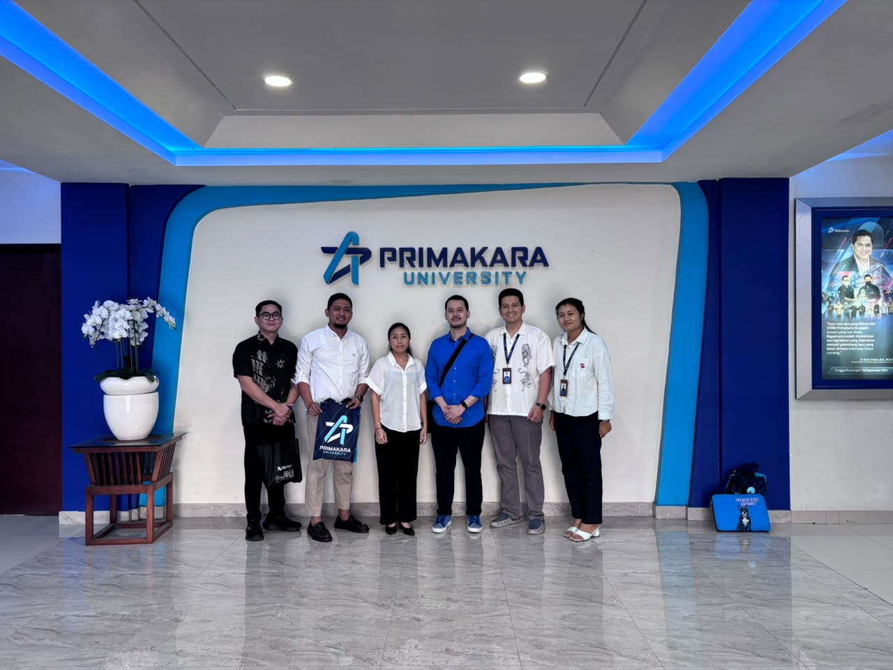 Group photo of the Deakin University delegation with Primakara University representatives at the campus lobby